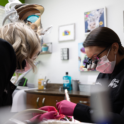 Dentist and dental assistant treating a patient