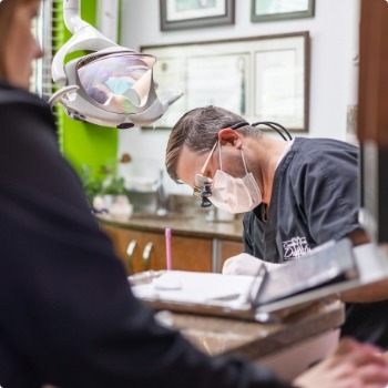 Dentist performing dental implant surgery