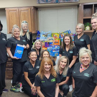 Weatherford dental team members with donated food