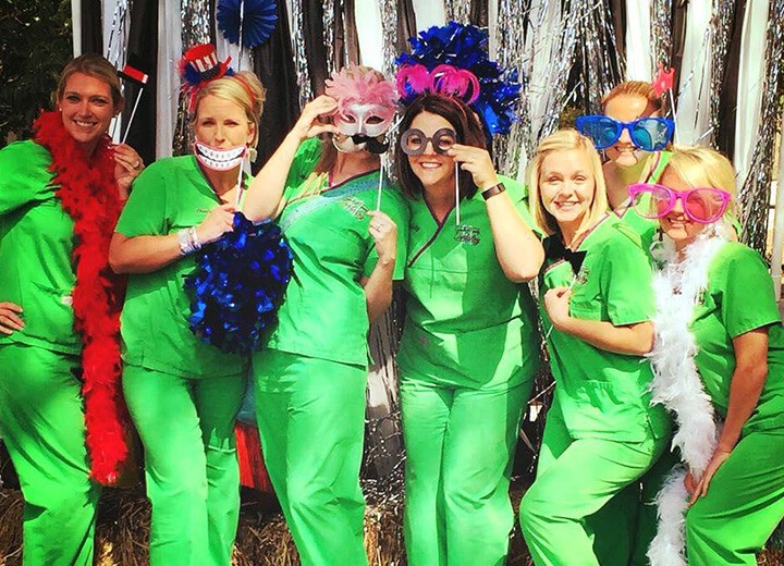 Dental team members dressed in silly hats and glasses