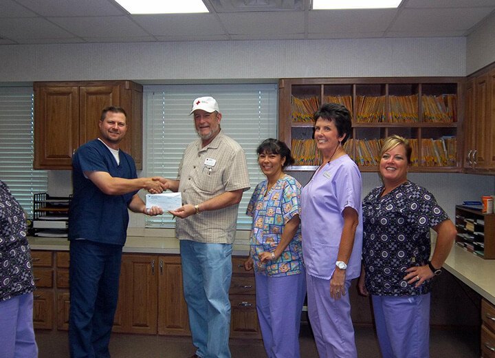 Man shaking hands with Weatherford dentist in dental office