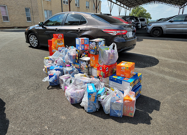 Several grocery bags filled with donated food items