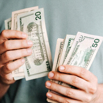 close up of man counting cash