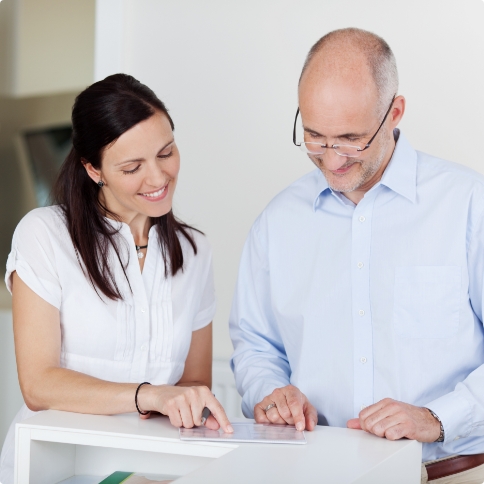 Dental team member showing a paper form to a patient