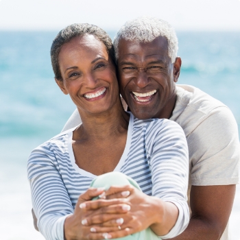 Older man and woman smiling together outdoors