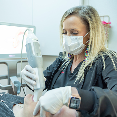 Dental team member taking dental impressions of a patient