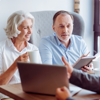 Man and woman at desk with laptop