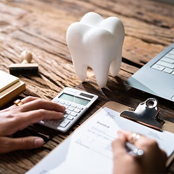 Person filling out paperwork on a desk