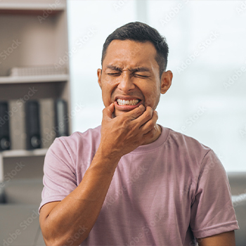 Man holding both sides of his jaw in pain