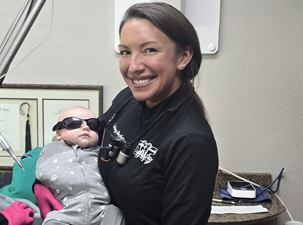 Baby wearing sunglasses in dental treatment room