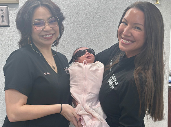 Dr. Decker and team member holding baby