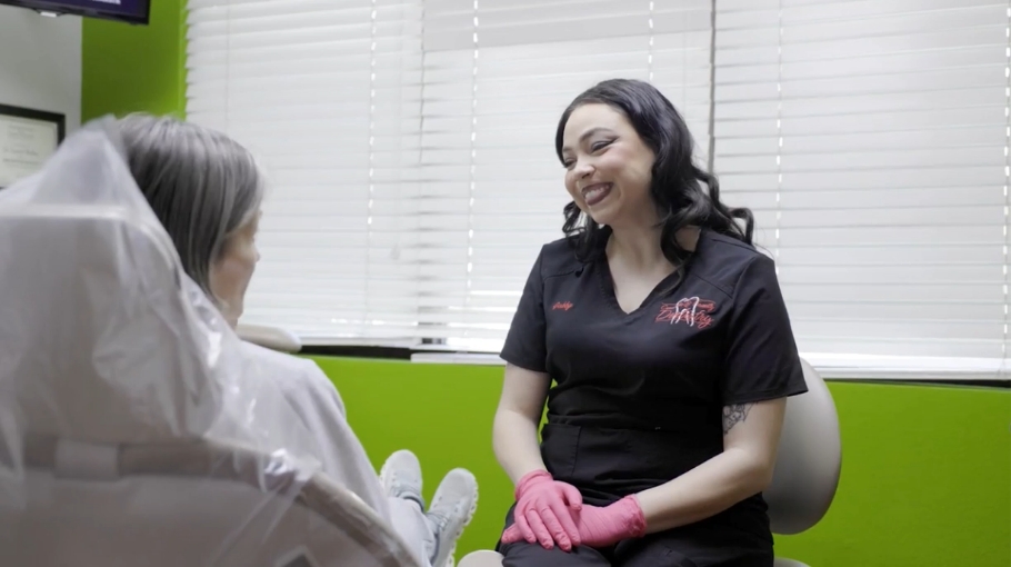 Weatherford dentist smiling while talking to a patient in the dental chair