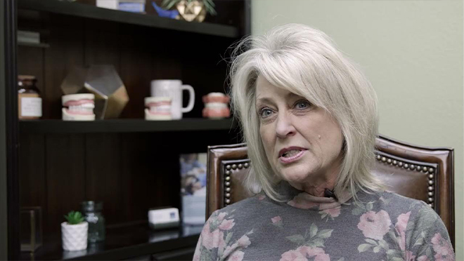 Senior woman in floral blouse sitting in dental office in Weatherford