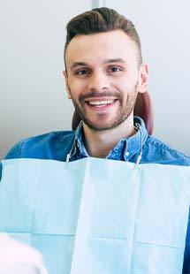 Man smiling while getting a dental checkup