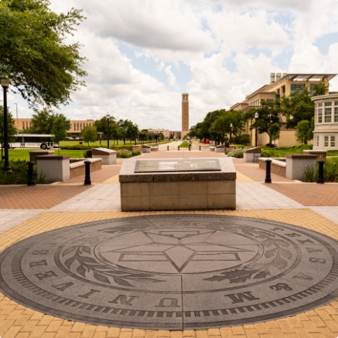 Texas A and M University seal on ground of courtyard