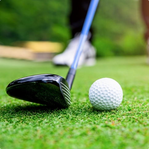 Close up of golf ball about to be hit by golf club