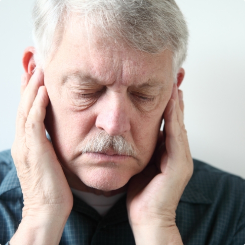 Man holding his temples in pain before T M J treatment in Weatherford