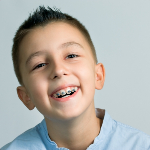 Young boy with braces smiling