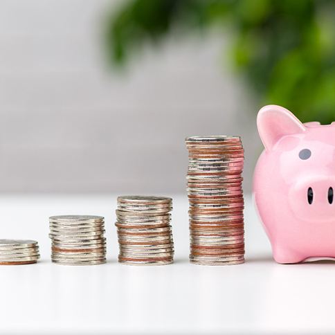 Money next to a piggy bank