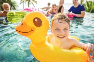 child and family at a pool