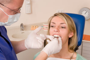 Dentist checking fit of Invisalign tray