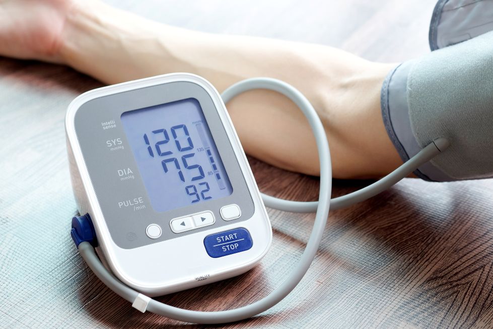 A person checking their blood pressure with a pressure cuff