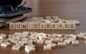 Wooden tiles spelling out the words “Gum Disease”