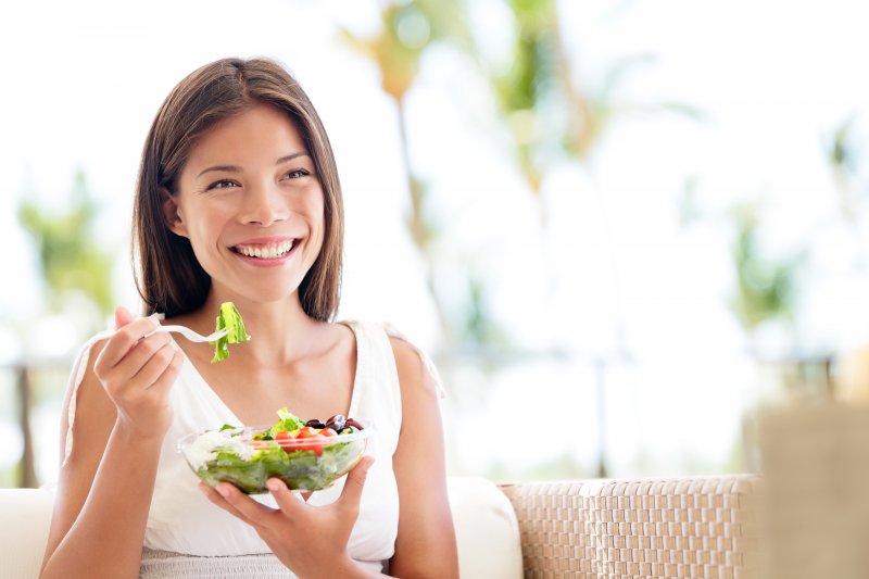 Someone with a nice smile eating a salad