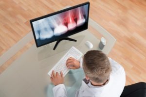 A dentist on a computer.
