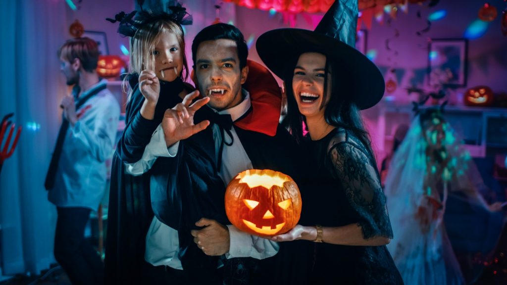 Closeup of family smiling during Halloween party